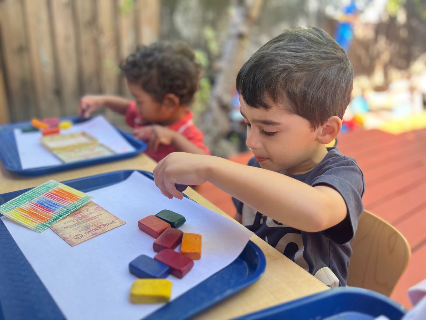 Child sorting colorful Stockmar block crayons
