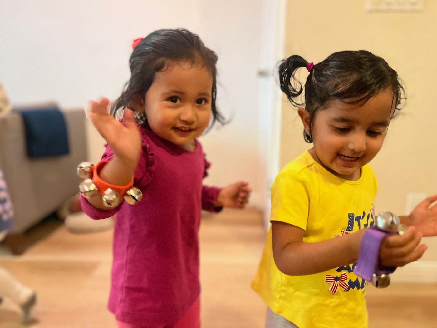 Children dancing with bell bracelets during music time